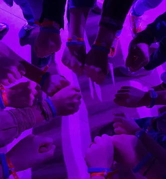 Yuma team stacking hands together at an event